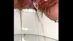 Play Pee diary. welcome to my toilet. a hairy pussy pees and piss runs down her white thighs. young girl pissed splashing.